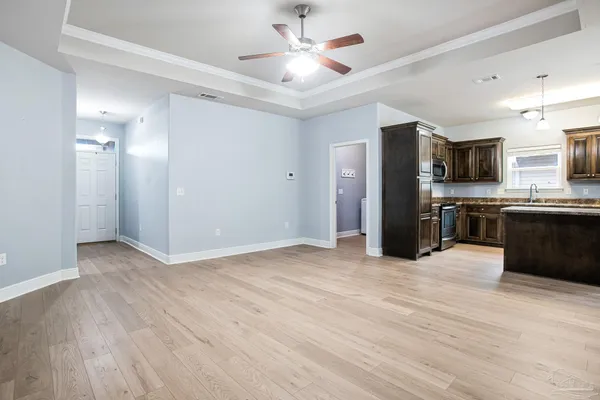 a view of kitchen with refrigerator microwave and cabinets