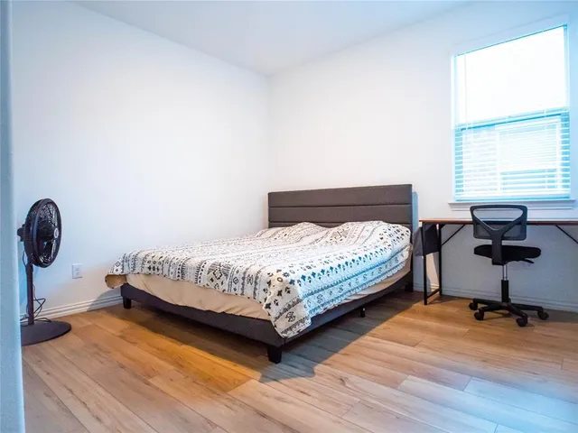 a bedroom with a bed and window