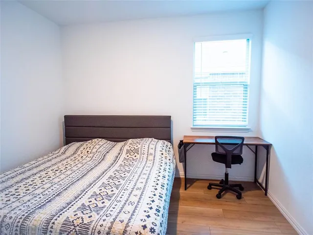 a bedroom with a bed and a desk