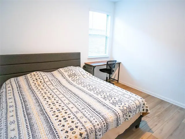 a bedroom with a bed and a window