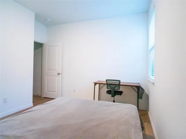 a bedroom with a bed and chair