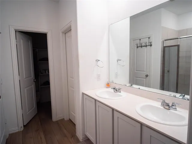 a bathroom with a double vanity sink and mirror