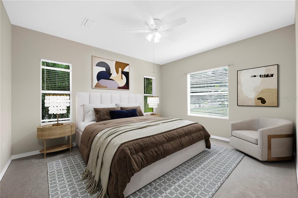 4326 Forest Creek Trail Parrish, FL 34219 - Photo 4 of 73 a bedroom with a large bed and a couch