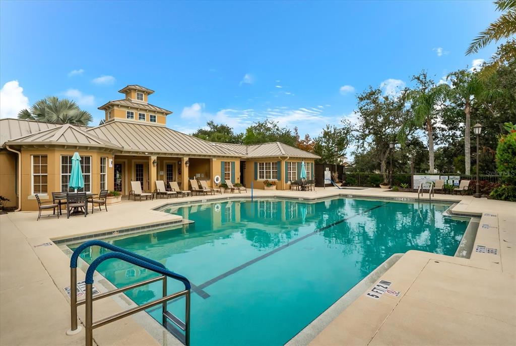 4326 Forest Creek Trail Parrish, FL 34219 - Photo 65 of 73 a front view of a house with swimming pool having outdoor seating