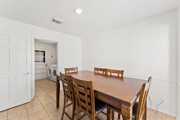 an empty room with wooden floor ceiling fan and windows