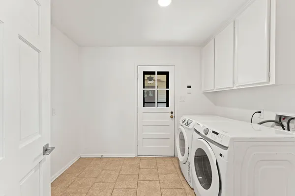 a bathroom with a granite countertop sink a mirror and shower