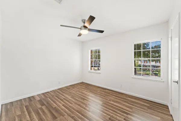 a spacious bedroom with a bed and a window