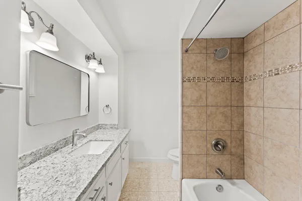 a bedroom with a bed and a ceiling fan