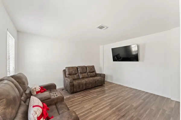 a view of a room with wooden floor and window