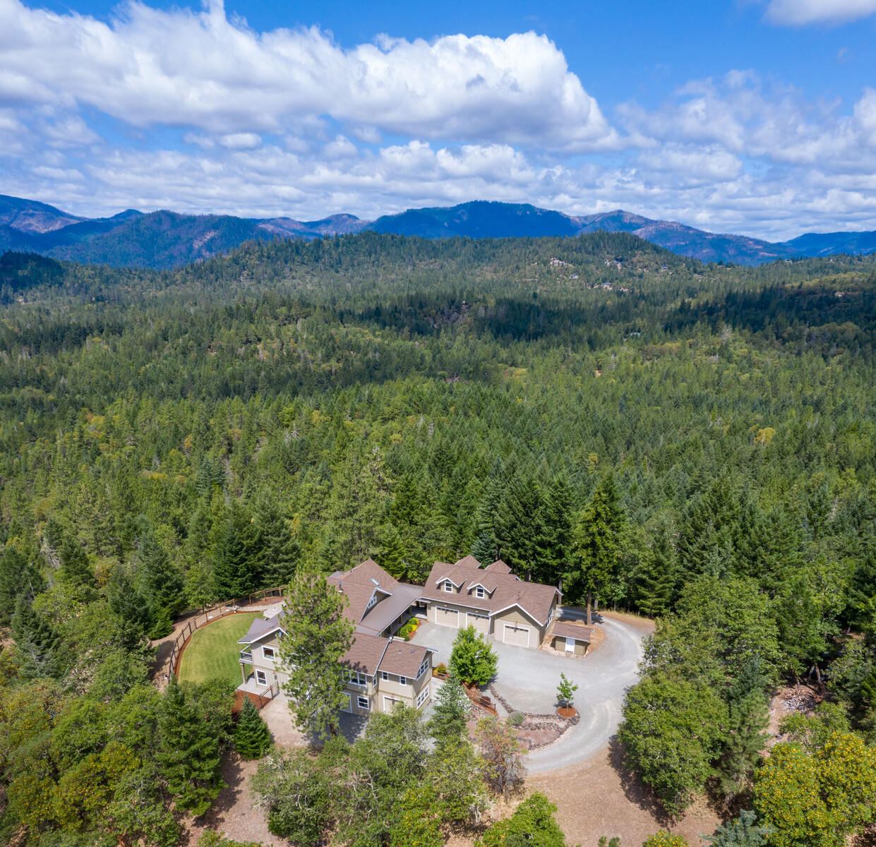 1882 Stewart Road Grants Pass, OR 97526 - Photo 1 of 44 a view of a lush green hillside and houses