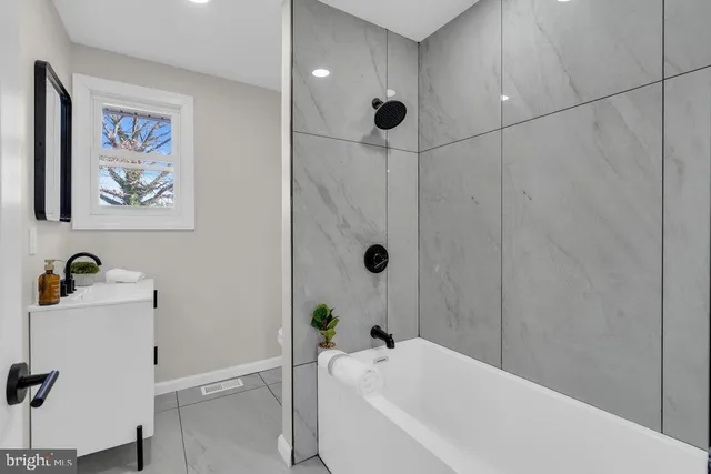 a bathroom with a bathtub and a shower