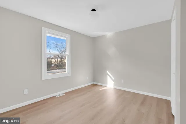 a view of room with window and hardwood floor