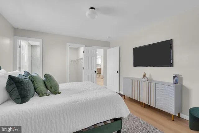 a bedroom with a bed and a flat screen tv