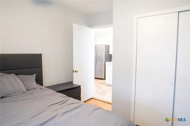 a bedroom with a bed and a glass door