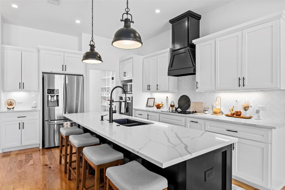 4346 Highway 21 Paige, TX 78659 - Photo 15 of 40 a kitchen with stainless steel appliances granite countertop a sink a stove a refrigerator and cabinets