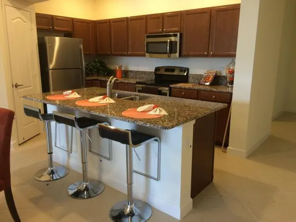 a kitchen with stainless steel appliances granite countertop a sink and cabinets