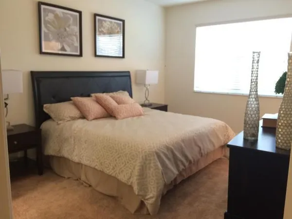 a bedroom with a bed and a night stand