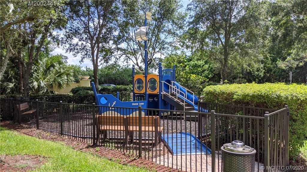 9503 Southwest Merlin Court Stuart, FL 34997 - Photo 5 of 6 a view of a roof deck with wooden fence and a bench