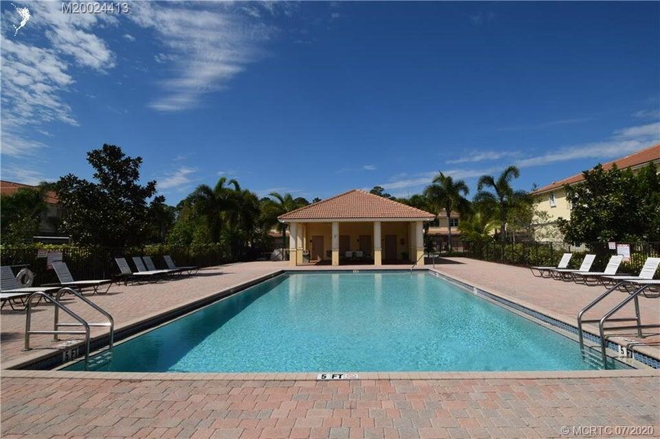 9503 Southwest Merlin Court Stuart, FL 34997 - Photo 6 of 6 a view of a house with pool fire pit tables and chairs