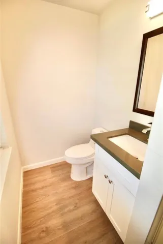 a bathroom with a toilet and a mirror