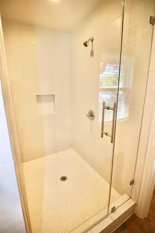 a bathroom with a tub and shower