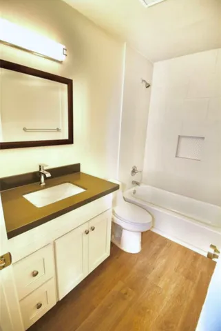 a bathroom with a sink a toilet and a bathtub