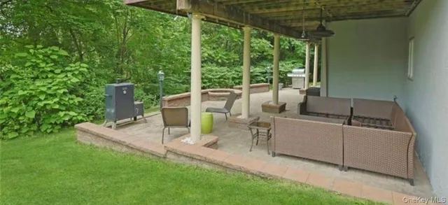 a view of a patio with a table chairs and a backyard