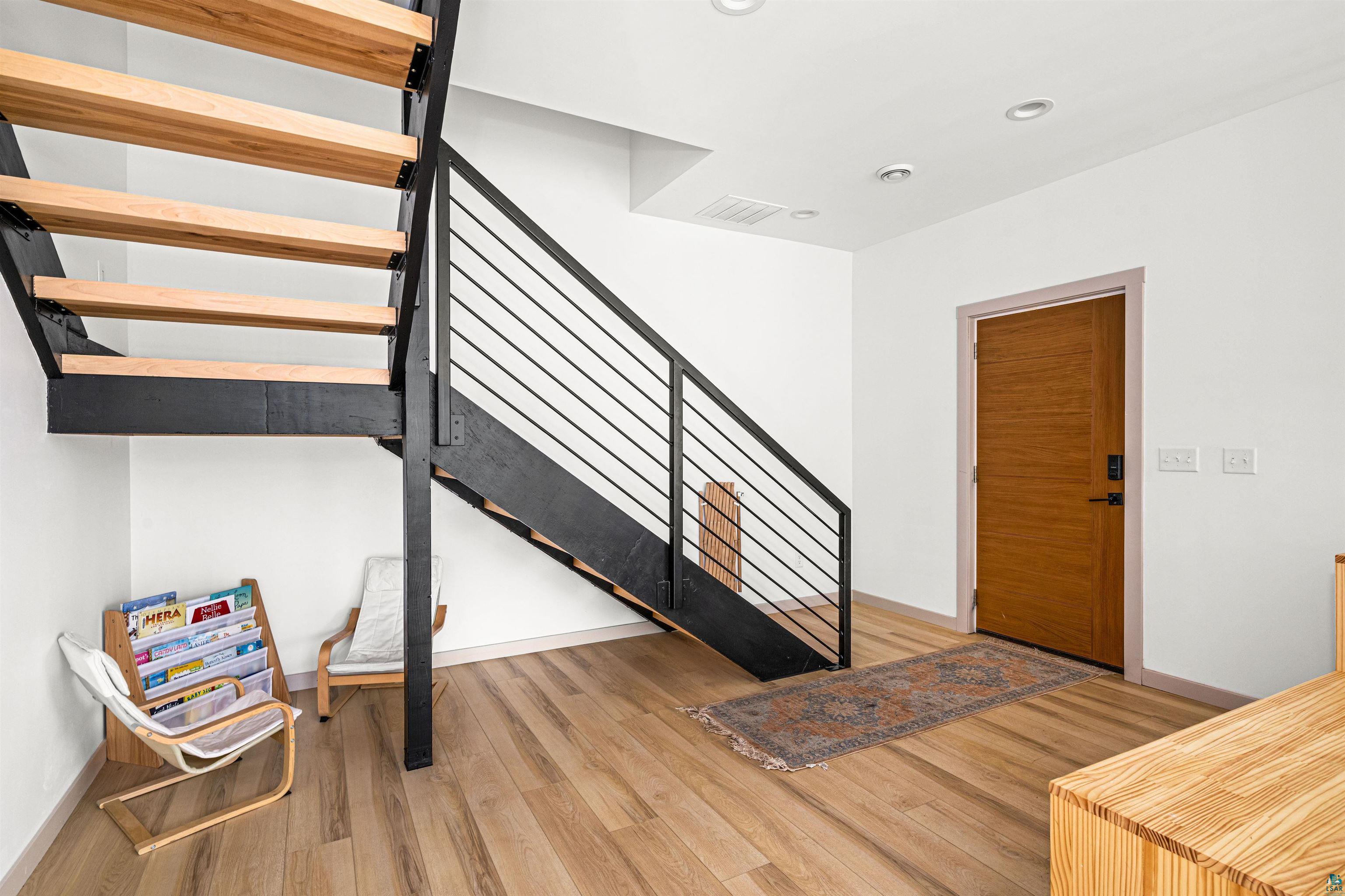 1825 East Shilhon Road Duluth, MN 55804 - Photo 8 of 37 Modern crafted open-tread staircase with black metal stringers and birch treads.