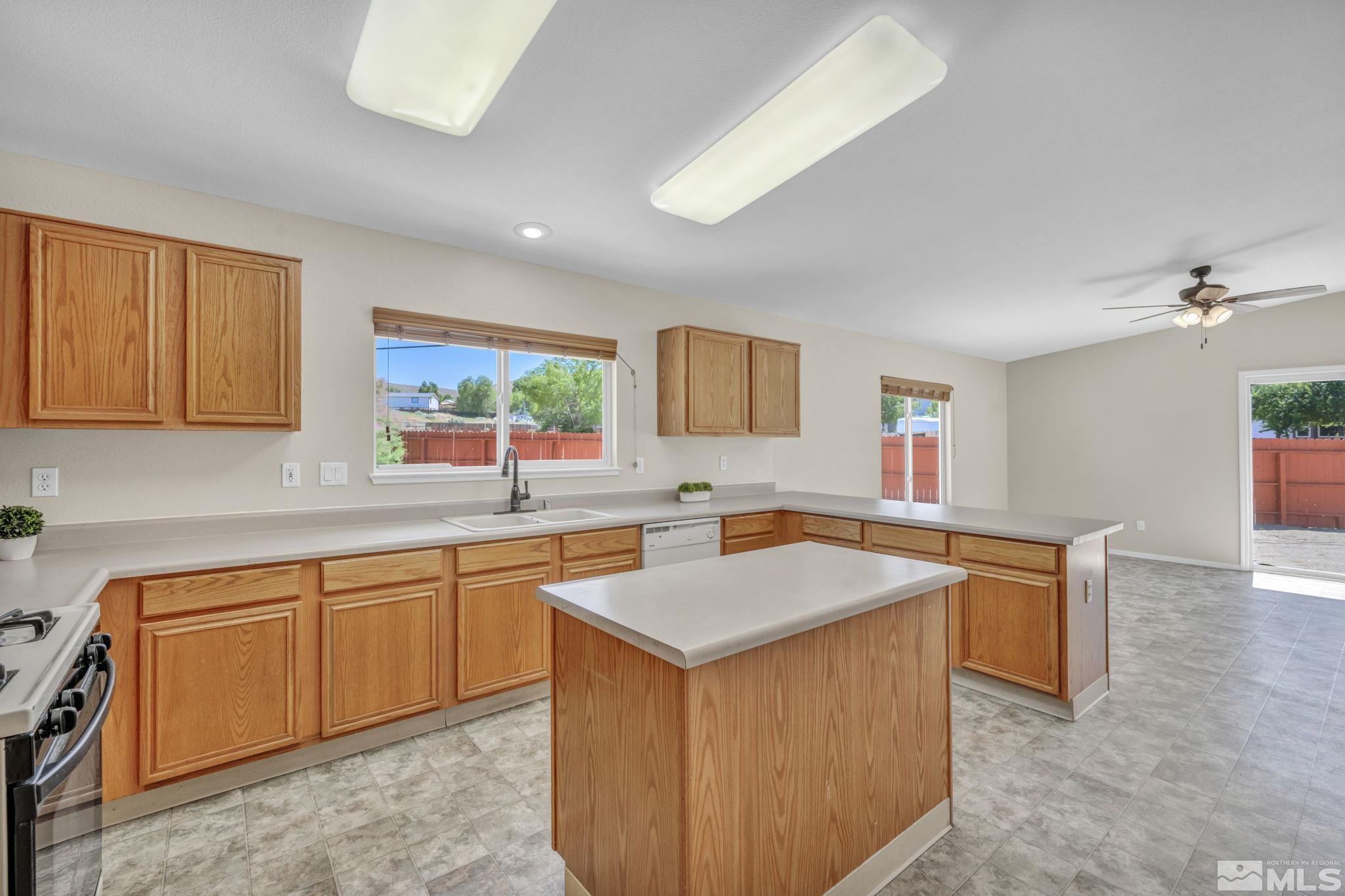 17588 Sunstone Court Reno, NV 89508 - Photo 3 of 26 a kitchen with a sink stove and cabinets
