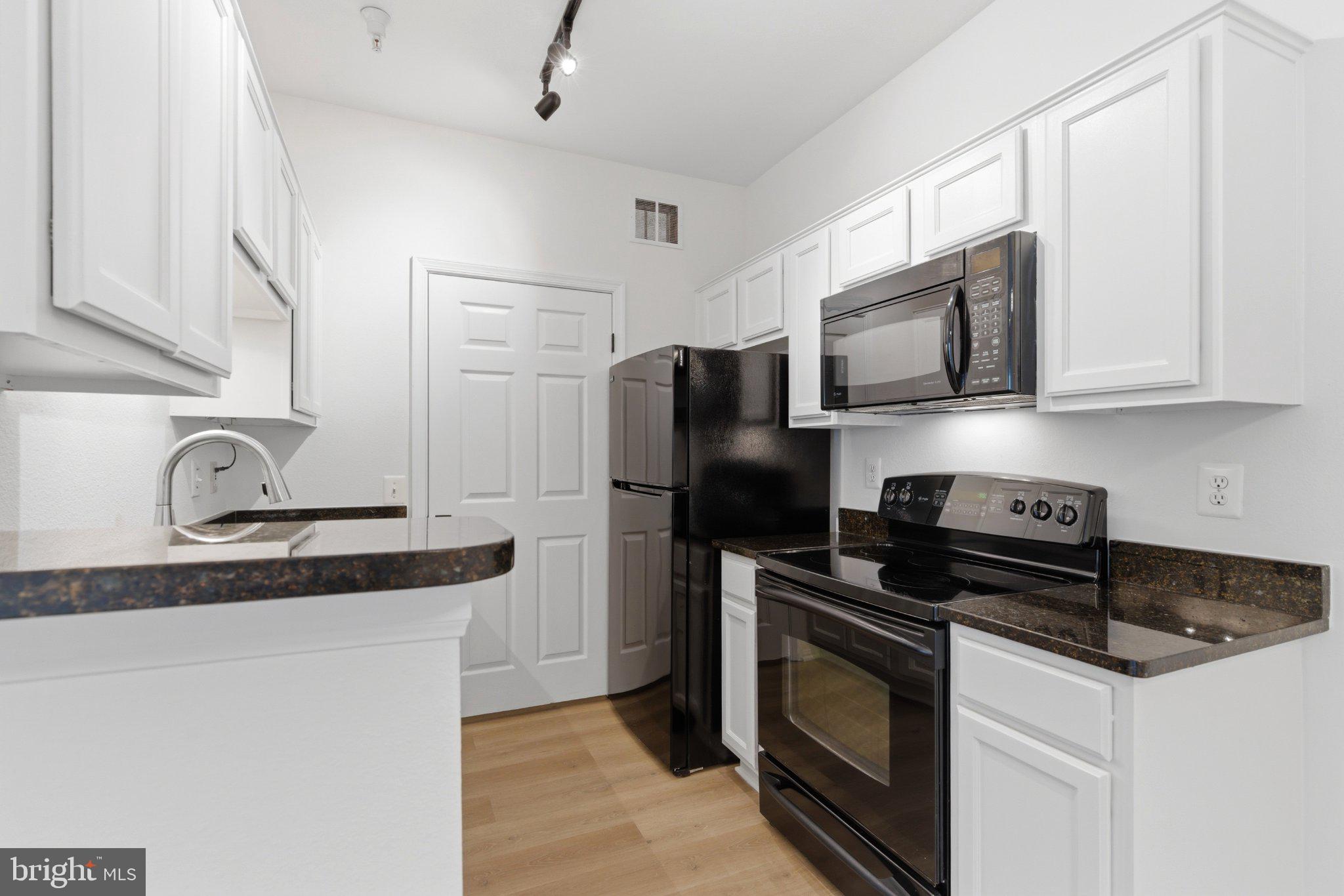 1580 Spring Gate Dr., Unit 4303 McLean, VA 22102 - Photo 10 of 41 Modern kitchen with sleek finishes.