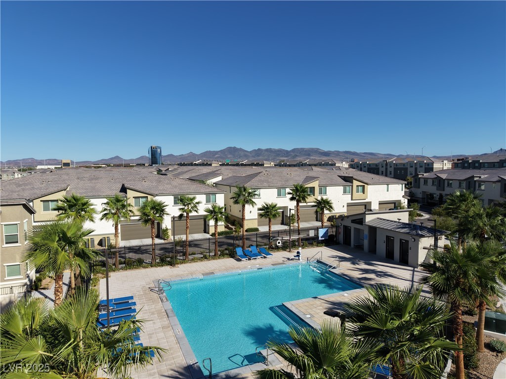 12280 Golden Wreath Road, Unit 3 Las Vegas, NV 89183 - Photo 52 of 57 Community pool with a patio area, a residential view, and a mountain view