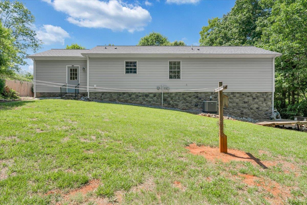 1124 Homeplace Road Bedford, VA 24523 - Photo 34 of 47 a backyard of a house with potted plants and wooden fence