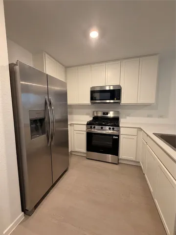 a kitchen with a refrigerator stove and microwave