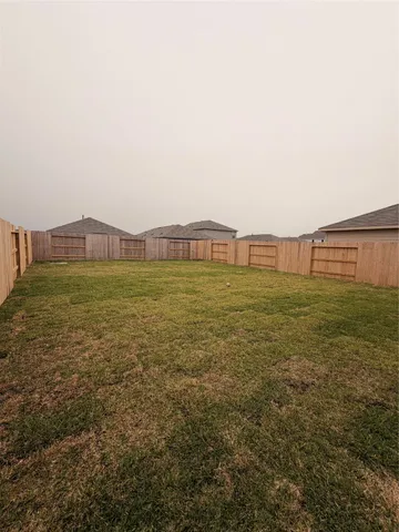 a view of a field with an ocean view