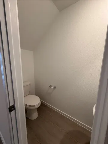 a white toilet sitting next to a shower