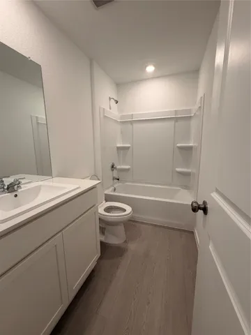 a bathroom with a double vanity sink toilet and shower