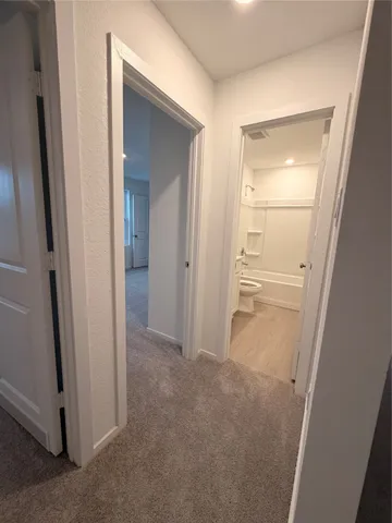 an empty room with mirror and a sink