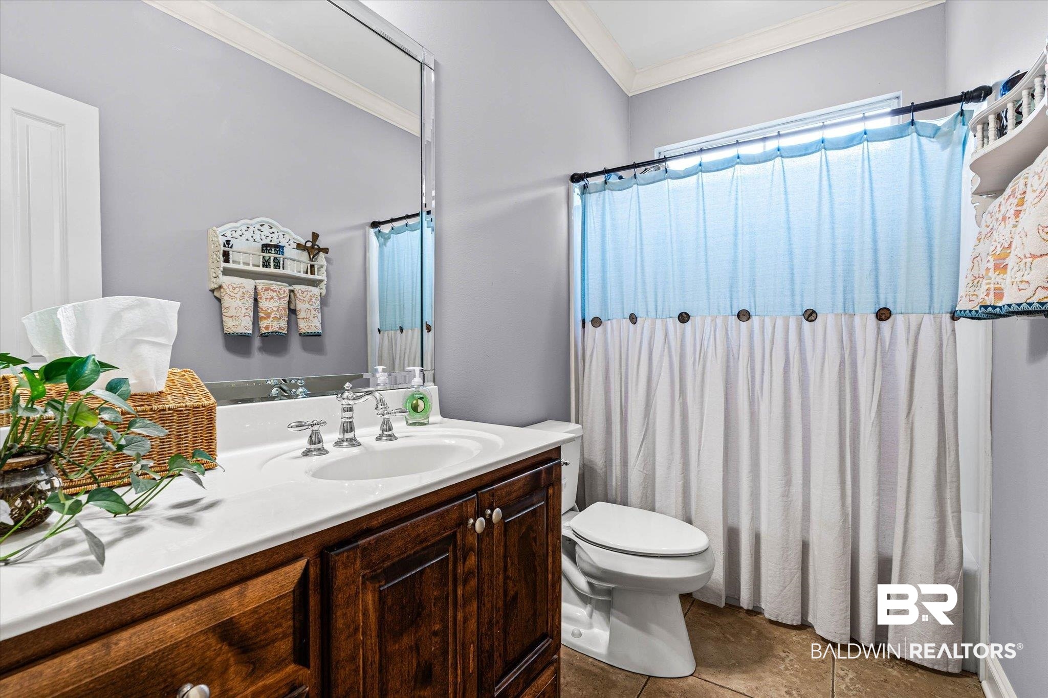 9916 Windmill Road, Unit 14 Fairhope, AL 36532 - Photo 10 of 12 Full bathroom featuring crown molding, vanity, light tile patterned flooring, and shower / tub combo