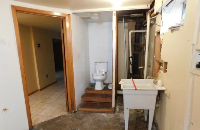 a bathroom with a toilet sink and shower