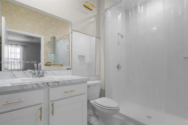 a view of an empty room and closet area