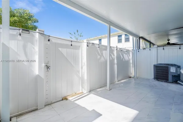 a view of a hallway with a glass door and entryway
