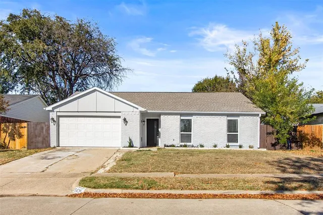 a view of garage yard and front view of a house