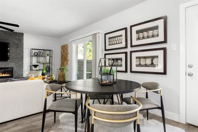 a view of a dining room with furniture and a potted plant