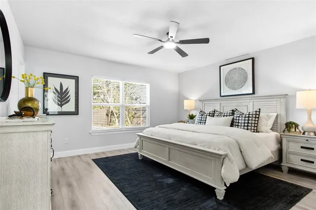 a bedroom with a large bed and a window