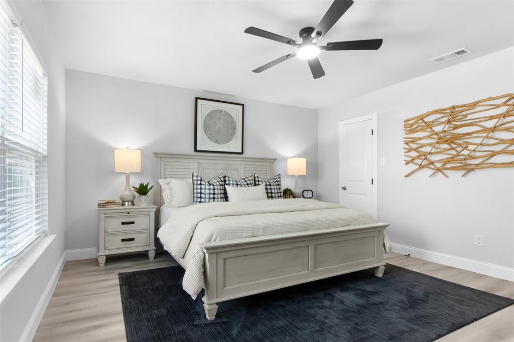 5405 Ramsey Drive The Colony, TX 75056 - Photo 17 of 32 a bedroom with a bed and a window