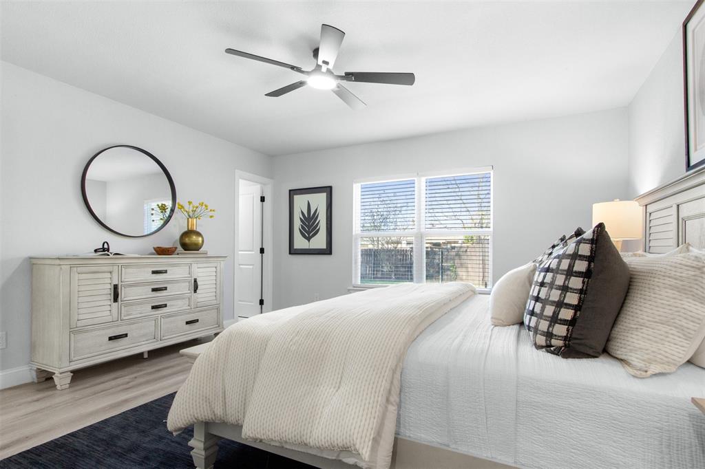 5405 Ramsey Drive The Colony, TX 75056 - Photo 18 of 32 a bedroom with a bed and a dresser
