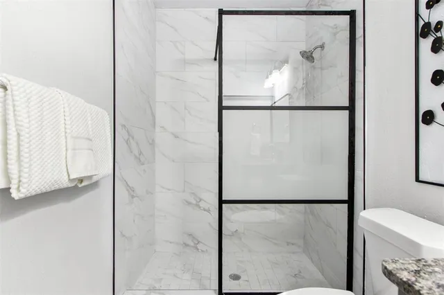 a view of a bathroom with a glass shower door