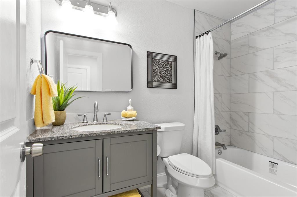 5405 Ramsey Drive The Colony, TX 75056 - Photo 24 of 32 a bathroom with a granite countertop sink mirror vanity and toilet