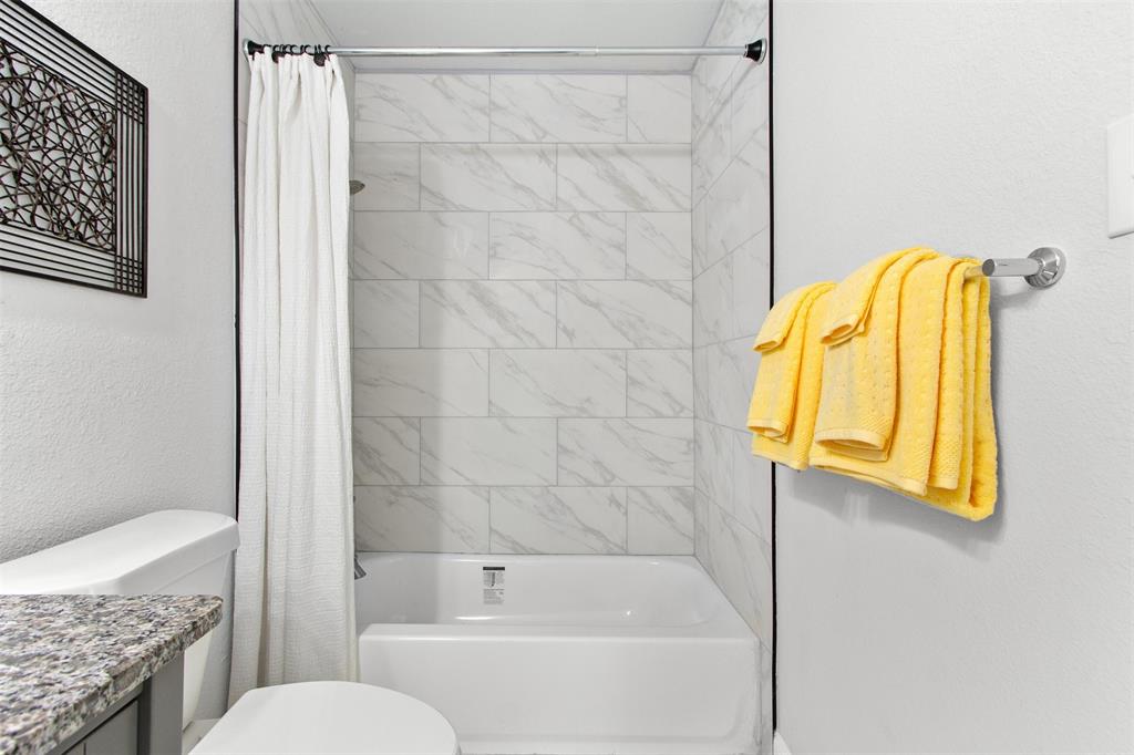 5405 Ramsey Drive The Colony, TX 75056 - Photo 25 of 32 a bathroom with a granite countertop sink and a mirror