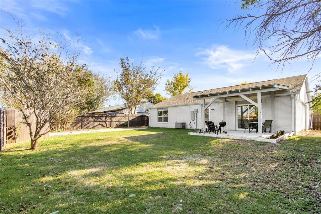 5405 Ramsey Drive The Colony, TX 75056 - Photo 29 of 32 a view of a house with a yard and garage